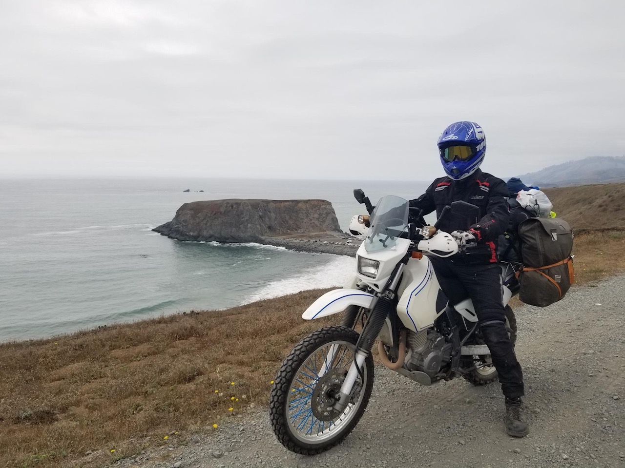 Dr. Oskar Triebe on his motorcycle at a coastal viewpoint